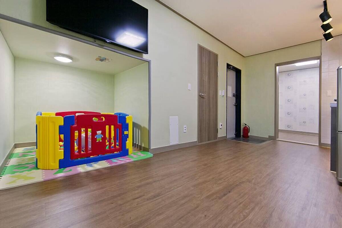 A spacious hallway with a play area featuring colorful foam blocks.
