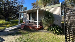 A single-story house with a covered porch, a front door, and a small front yard. - Deniliquin Pioneer Tourist Park (Deniliquin)