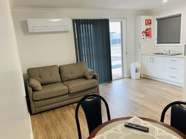 Deluxe Cabin | Living area | 20-inch flat-screen TV with digital channels, TV