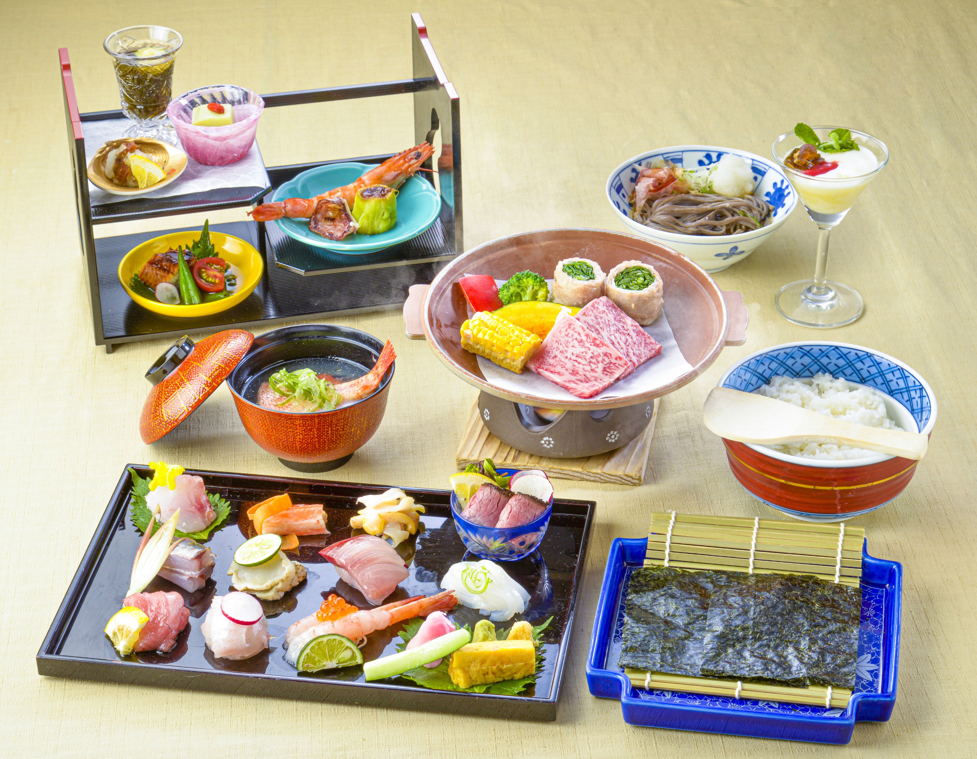 A variety of Japanese dishes including sashimi, sushi, and tempura, arranged on a tray.