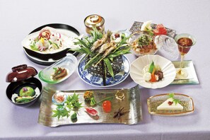 A variety of dishes and drinks on a table, including sushi, sashimi, and a martini glass. - The Grand Resort Arima (Kobe)