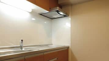 A modern kitchen with wooden cabinets, a stainless steel sink, and under-cabinet lighting.