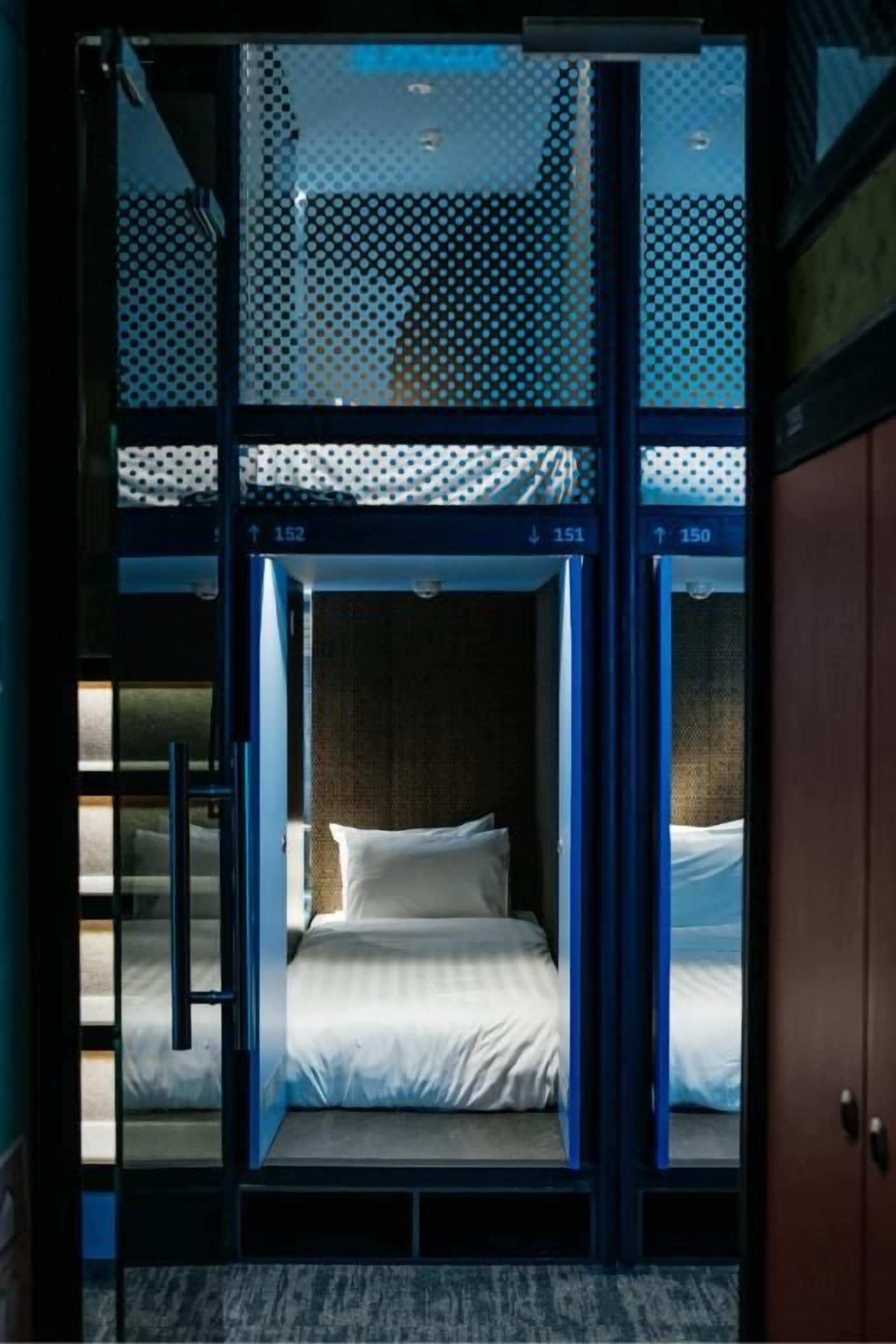 A room with a bed, a door, and a window.