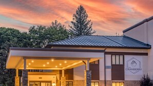 A modern building with a covered entrance, stone pillars, and a sign reading "The Cranberry." - The Cranberry, an Ascend Collection Hotel (Morgantown)
