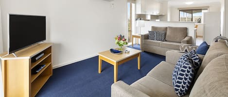 Apartment | Living area | 30-inch Smart TV with satellite channels