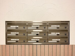 A row of mailboxes with labels and locks, indicating a secure mail delivery system.