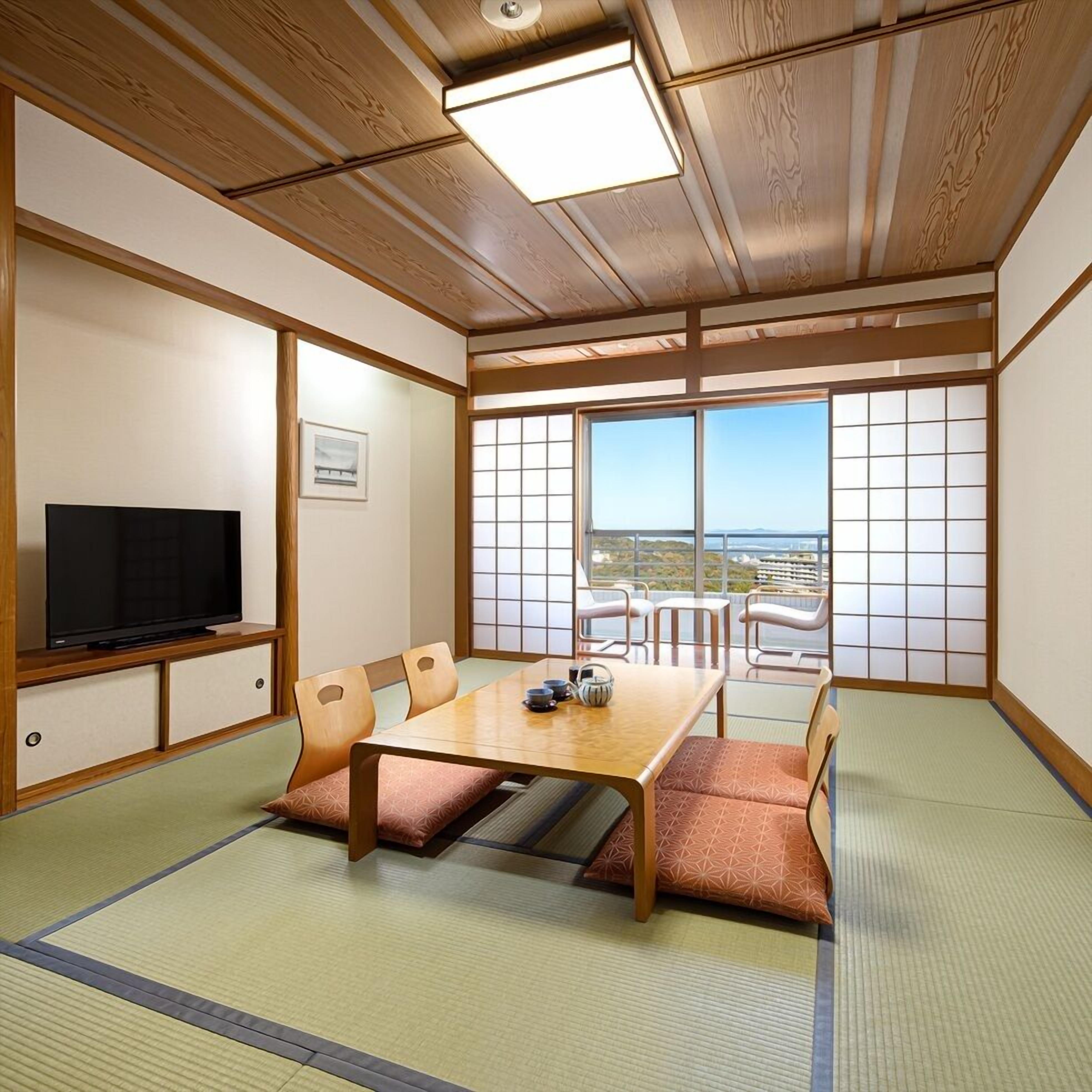 A traditional Japanese-style room with tatami flooring, a low table, and sliding shoji doors.