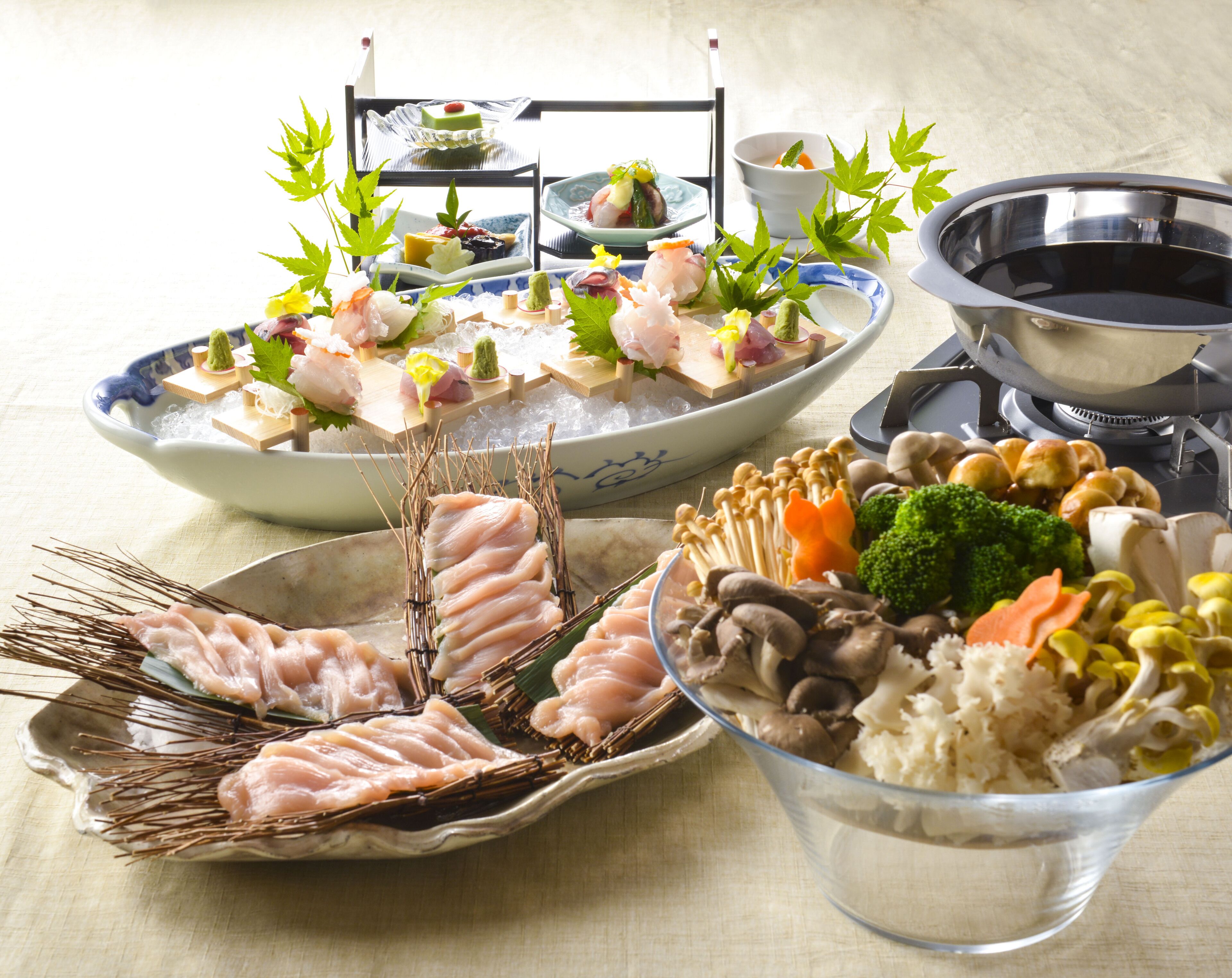 A variety of dishes including seafood, vegetables, and rice, arranged on a table with a traditional Japanese aesthetic.