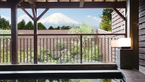 A wooden deck with a metal railing, a stone ledge, and a reflection of a mountain in the water. - The Gran Resort Princess Fujikawaguchiko (Fujikawaguchiko)