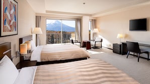 A hotel room with two beds, a desk, a chair, a TV, and a large window with a mountain view. - The Gran Resort Princess Fujikawaguchiko (Fujikawaguchiko)