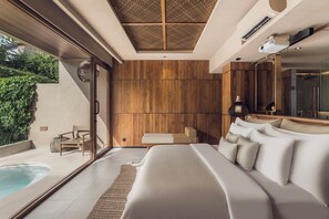 A modern bedroom with a large bed, a small bedside table, a bench, and a view of a swimming pool. - Sini Vie Resort & Spa Seminyak by Ini Vie Hospitality (Keroboken Kelod)