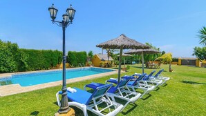 A swimming pool with lounge chairs and a lamp post. - Casa Quintero 4 dorm Conil de la Frontera by Ruralidays (Cádiz)
