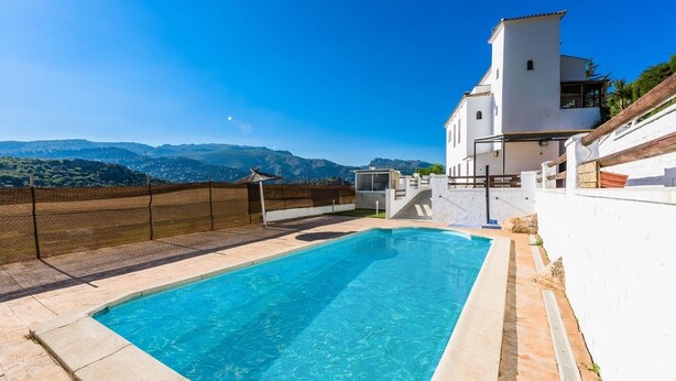 A swimming pool with a clear view of the mountains in the background. - La Mina Benaoján by Ruralidays (Málaga)