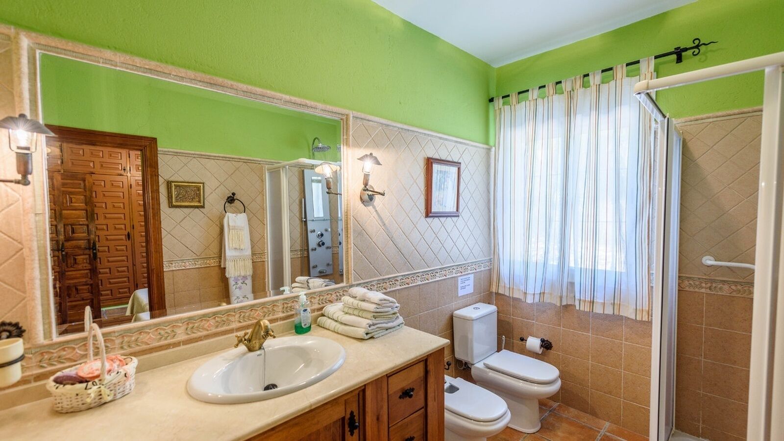 A bathroom with a sink, toilet, and shower.