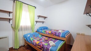 A bedroom with two bunk beds, a window with sheer curtains, and wall-mounted shelves. - Los Morales Ronda by Ruralidays (Málaga)