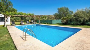 A rectangular swimming pool with a wooden pergola and lounge chairs. - Los Morales Ronda by Ruralidays (Málaga)