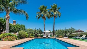A heated pool, sun loungers