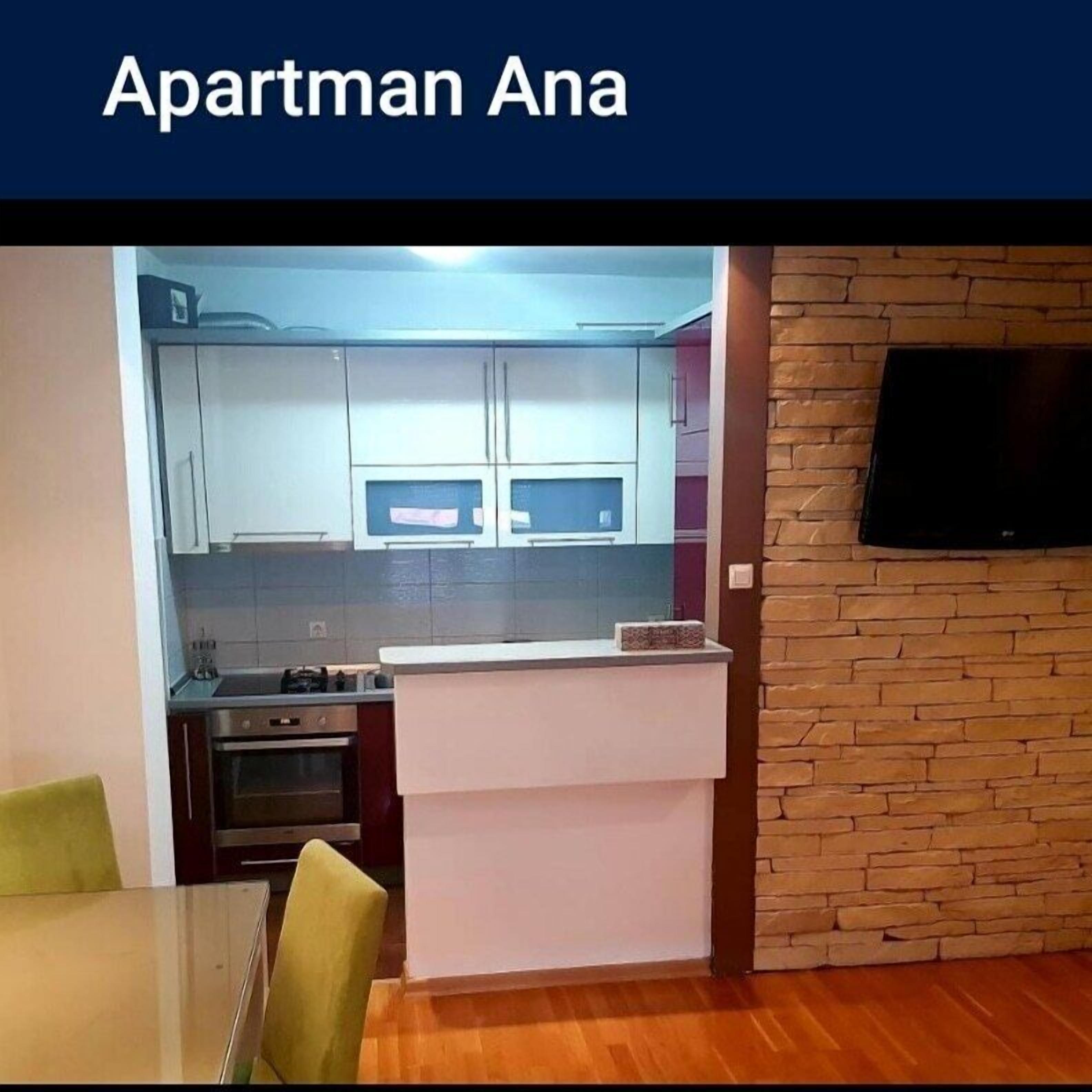 A compact kitchen with cabinets, a stove, and a dining area with a table and chairs.