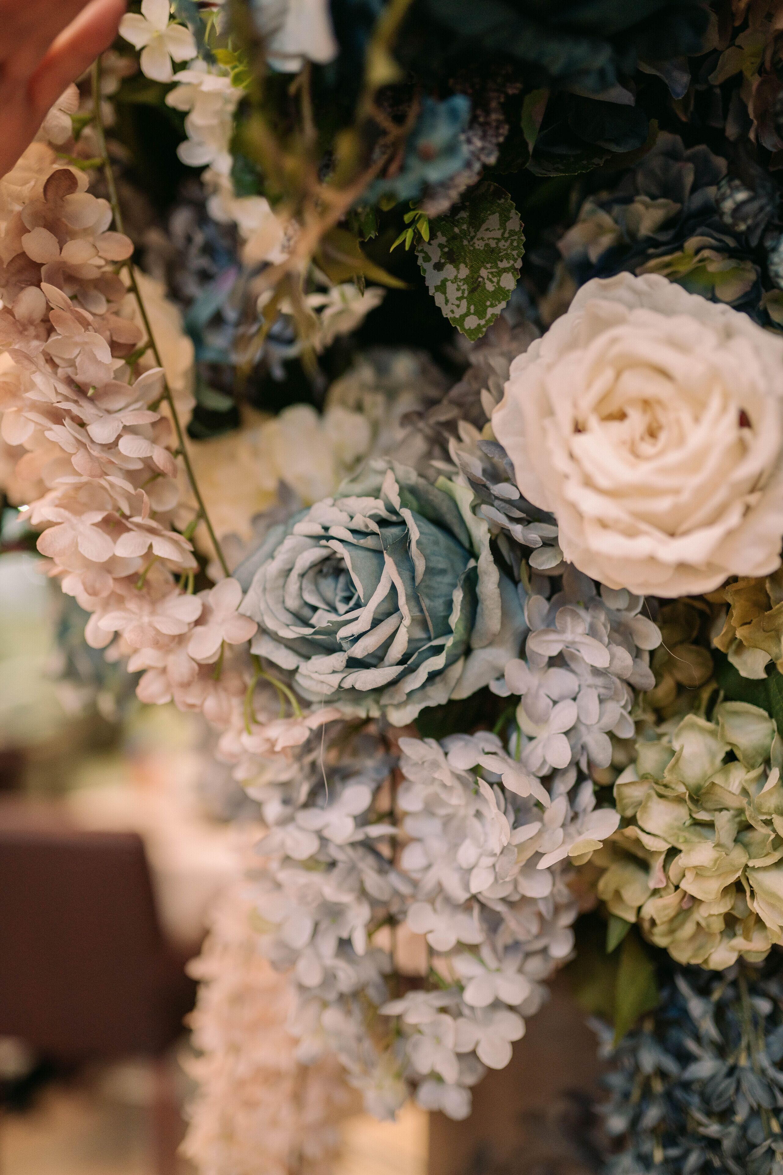 A close-up of a floral arrangement with various flowers and greenery.