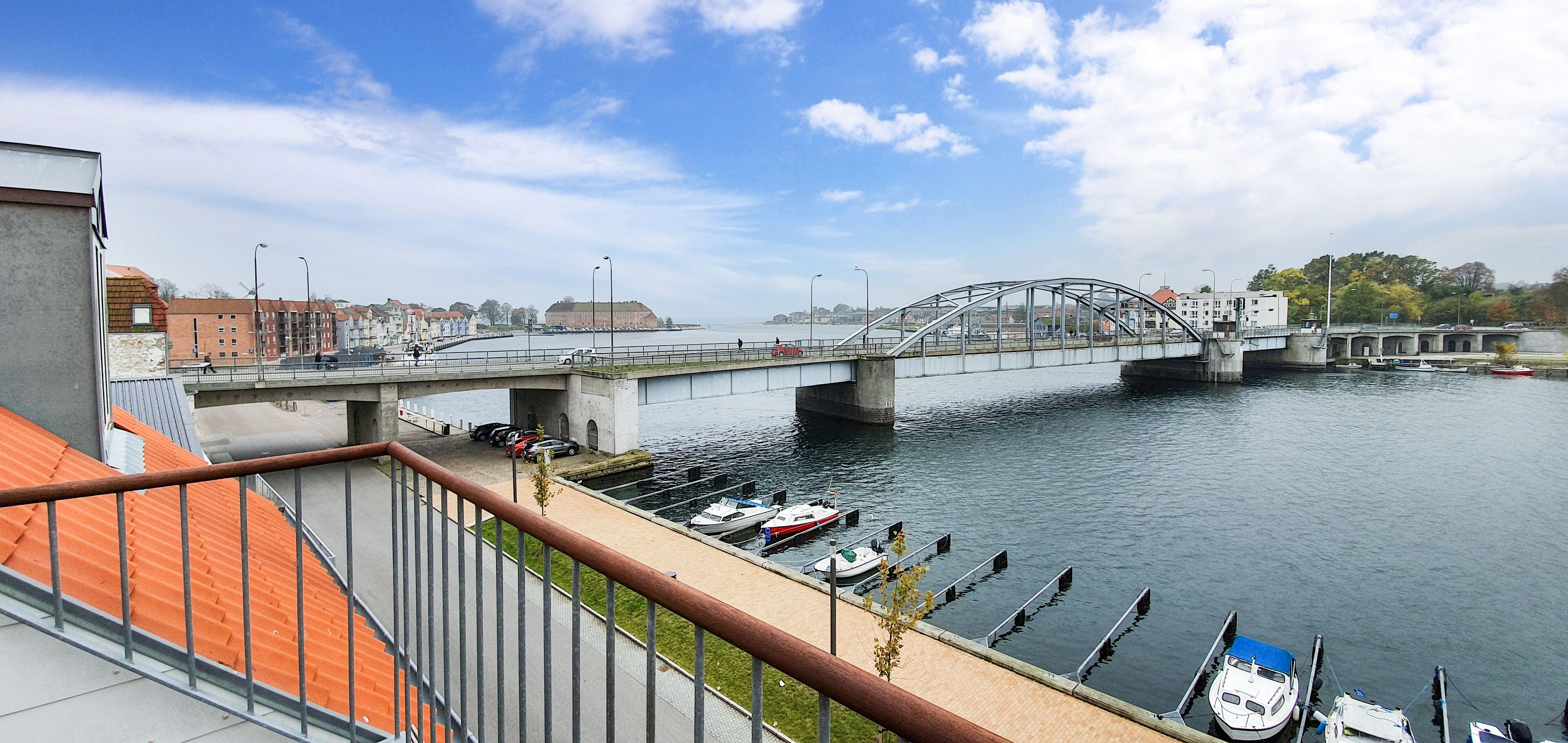 Un pont enjambant une rivière, avec des bateaux amarrés dans le port de plaisance.