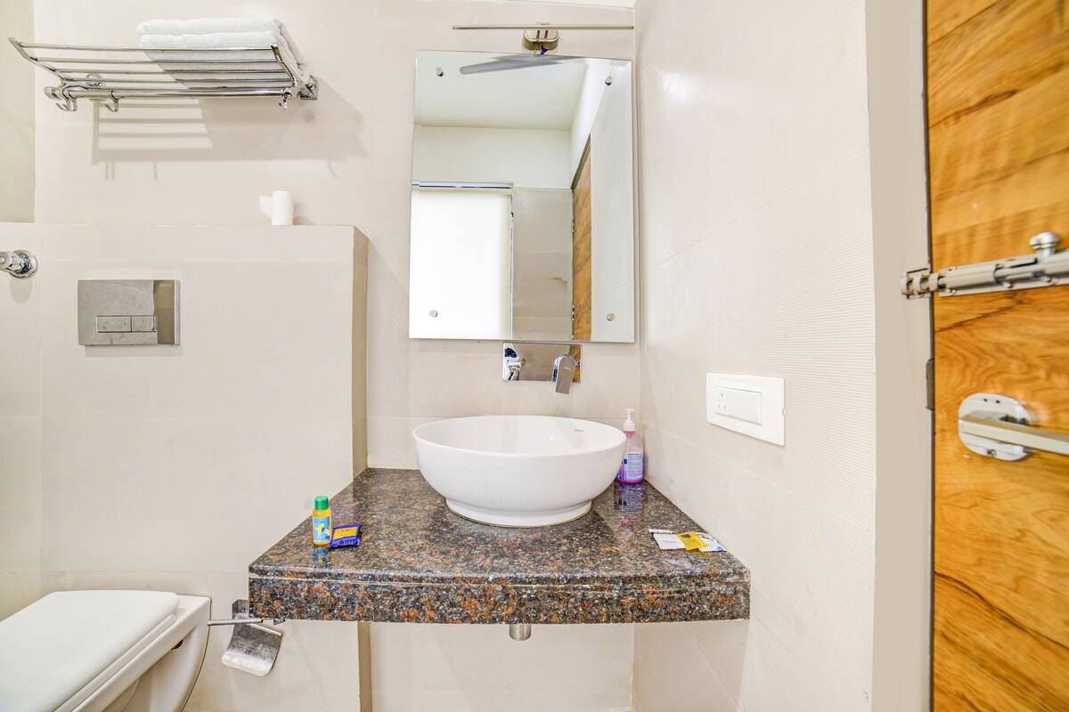 deluxe room | bathroom | shower, rainfall showerhead, free toiletries, slippers