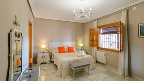 A well-lit bedroom with a bed, bedside tables, a bench, a mirror, and a window with curtains. - Torreón de Morayma Baena by Ruralidays (Córdoba)