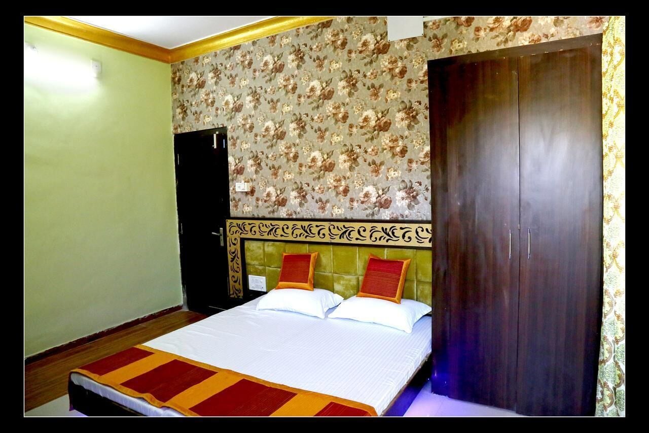 A room with a bed, a wardrobe, and a door.