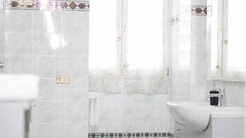 Separate tub and shower, rainfall showerhead, free toiletries