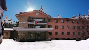 A hotel with a stone facade, a balcony, and a sign reading "Edelweiss." - Hotel Edelweiss (Samokov)