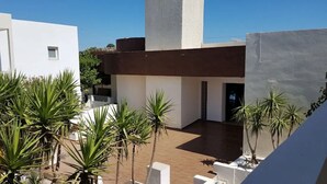 A modern building with a flat roof, a central tower, and a courtyard with potted plants. - Anavadia Hotel By Anayia All Inclusive Resorts (Rhodes)