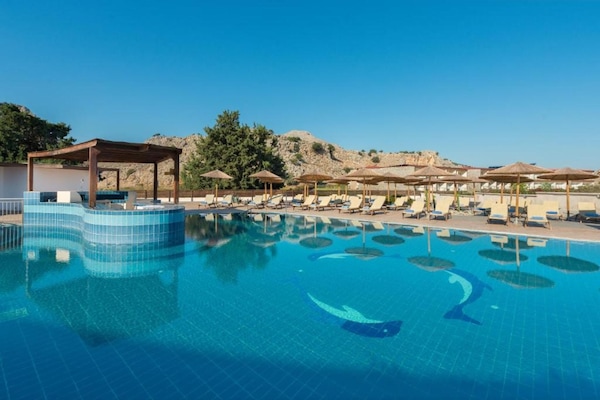 Seasonal outdoor pool, open 10:00 AM to 6:00 PM, pool umbrellas