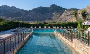Relax by the pool surrounded by mountainous terrain.