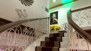 A staircase with ornate metal railings and patterned carpeted steps. - Hotel Rey (Camaçari)