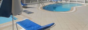 Outdoor pool, pool umbrellas, sun loungers