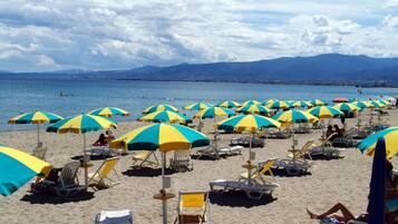 Am Strand, Liegestühle, Sonnenschirme