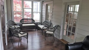 A covered porch with wicker furniture and a ceiling fan. - Atlantic City Beach Retreat, Casino Fun, & 5-Min Walk to the Beach (Atlantic City)