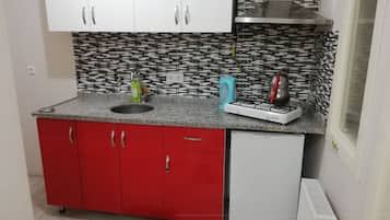 Apartment | Private kitchen | Mini-fridge, stovetop, cookware/dishes/utensils, cleaning supplies