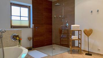 Bathtub, hair dryer, towels, toilet paper