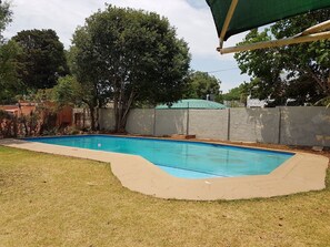 Outdoor pool, open 6:00 AM to 6:00 PM, pool umbrellas