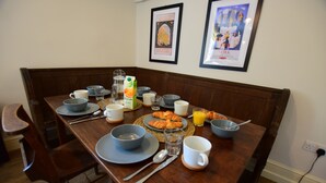A breakfast table set with plates, bowls, cups, and croissants. - 87 Micklegate (York)