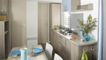 Mobile Home | Private kitchenette | Full-sized fridge, stovetop, cookware/dishes/utensils, dining tables