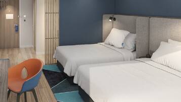 A hotel room with two beds, a chair, and a wooden floor.