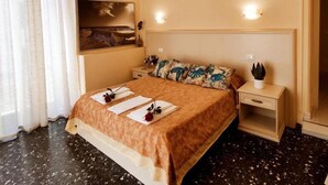 Une chambre d’hôtel avec un grand lit, une table de chevet, une commode et une œuvre d’art accrochée au mur.
