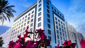 A modern hotel building with a prominent sign at the top.