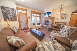 A cozy living room with a fireplace, comfortable seating, and artwork on the walls. - Lone Eagle 3026 (Keystone)