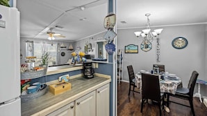 A kitchen with a wooden countertop, a refrigerator, and a dining area with a table and chairs. - 25%Off/Disney 9 mi/Heated Pool/PlayYard/Gym/Courts (Davenport)
