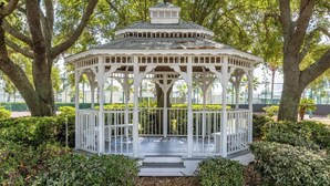 A white gazebo with a hexagonal roof, surrounded by lush greenery and trees. - 25%Off/Disney 9 mi/Heated Pool/PlayYard/Gym/Courts (Davenport)