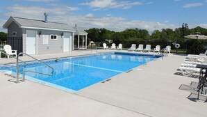 A swimming pool with a small building, lounge chairs, and a gazebo. - Cottage #22 - 3 bedroom/1 bath (Cape Vincent)