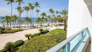 A beach view with palm trees, a sandy beach, and a clear blue sky. - Beachfront| 60" TV| Gym| FastWifi| Amazing View! (Juan Dolio)