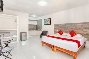A modern hotel room with a large bed, a dining table, and a small kitchenette. - Hotel Casa Ariana (Bacalar)
